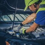 A mechanic works on a vehicle