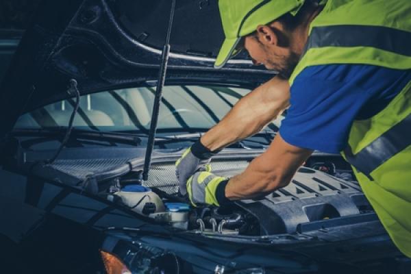 A mechanic works on a vehicle