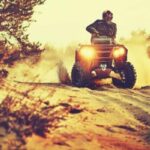 A man rides an ATV in a remote area