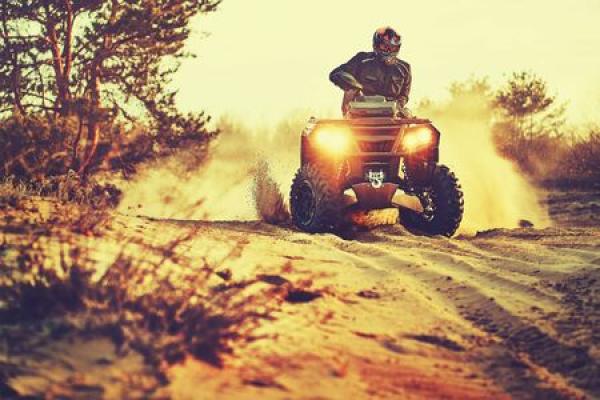 A man rides an ATV in a remote area